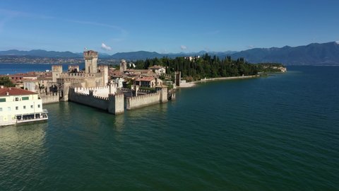 Point of interest aerial view of the historic city of Sirmione, Lake Garda, Italy. Sirmione island drone panorama. Slow flight along the historic Sirmione Castle.