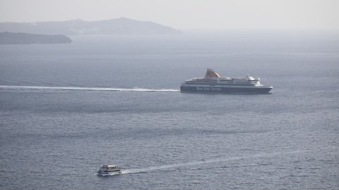 Santorini, Greece - September 18 2020: The ferry ship "Blue Star Ferries" departing Thera and passing through the caldera on Santorini island