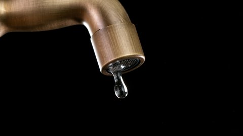 Super Slow motion of drop of water drips from the tap.