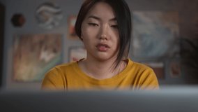 Asian woman using laptop during video conference call. Remote learning during coronavirus lockdown, happy Korean female chat with family and friends home isolation, living room, freelancer home office