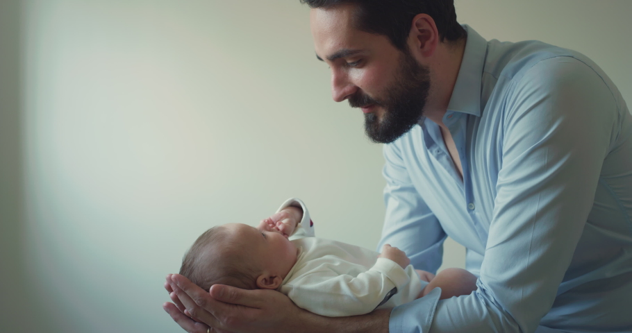 Cinematic shot of young neo father is playing with his newborn baby in a nursery in a morning. Concept of children, baby, parenthood, childhood, life, love, fatherhood, family. Royalty-Free Stock Footage #1070234770