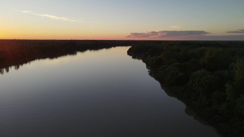 Beautiful aerial high shot of calm Amazon River at sunset