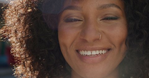 Portrait happy african american woman smiling in city