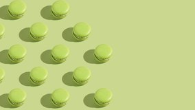 Green macaron pastries photographed on light green paper background appearing one by one creating a hard light pattern - Powered by Shutterstock - Get 15% off with code: PIKWIZARD15