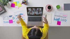 Top view of business woman talking about sale report in video conference. Asian team using laptop and tablet online meeting in video call.Working from home, Working remotely and Social isolation. - Powered by Shutterstock - Get 15% off with code: PIKWIZARD15