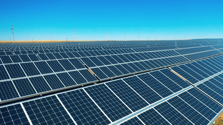 Drone shot of solar panel rows at a solar power facility Royalty-Free Stock Footage #1070258065