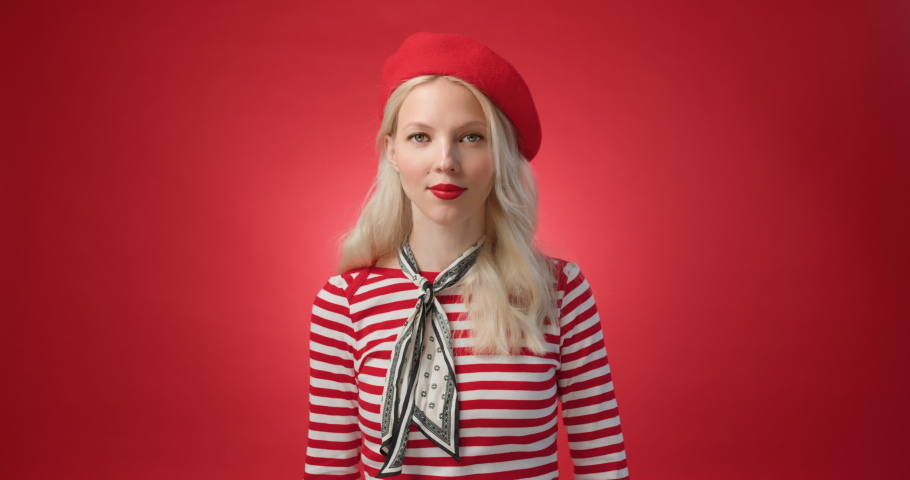 Funny young woman in red beret look at camera waving and happy shows air tickets and gesture. Trip canceled, fail because lockdown. Isolated red background Royalty-Free Stock Footage #1070259052