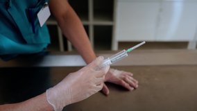 In this video, the doctor checks the syringe for injection