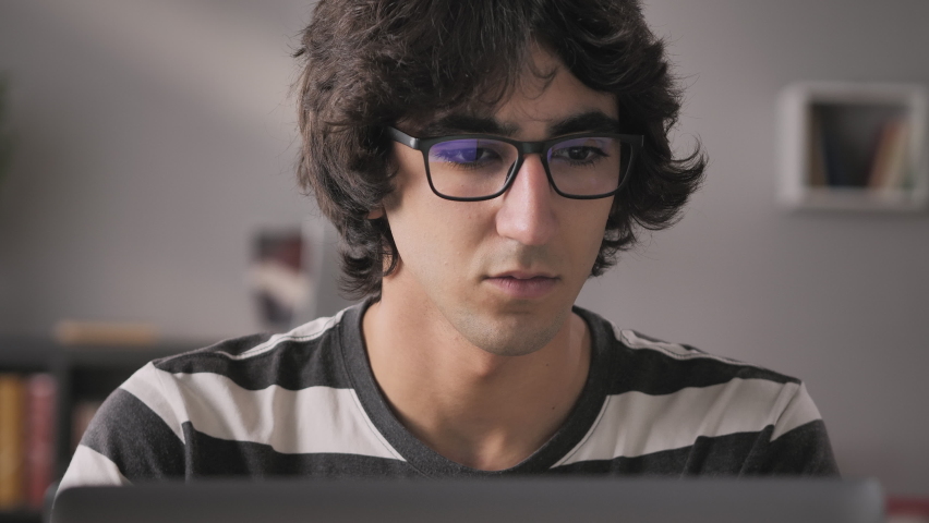 tired middle eastern man wearing glasses working at the computer has eyes ache pain,exhausted young arab male sits at his desk works from home takes off his eyeglasses Royalty-Free Stock Footage #1070261617