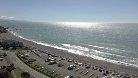 Vehicles Positioned At Beachfront RV Park Near Harbor Kite Field In Port Of Brookings, Oregon. - Aerial Drone Orbiting Shot