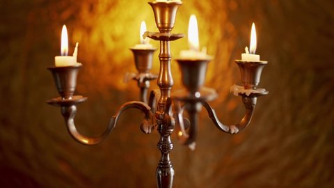 Vintage Rotating Candelabra With Lighted Stick Candles In Bokeh Glowing Background. - Rack Focus Shot