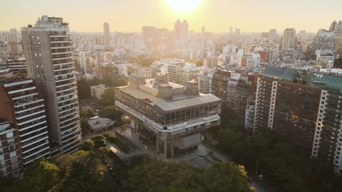 Buenos Aires , Argentina - 02 22 2021: Aerial establishing shot of National Library with buildings and sunset behind. Orbit