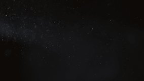 snowflakes grains rain fluff flies. glowing flying chaotically dust on a dark concrete plain background. small particles flying in the sun beam. slow motion video for the screensaver. blank card - Powered by Shutterstock - Get 15% off with code: PIKWIZARD15