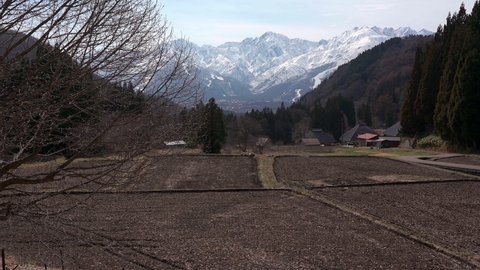 A village with rice terraces and Mt. Shirouma in the distance,hakuba village,Nagano Prefecture,japan