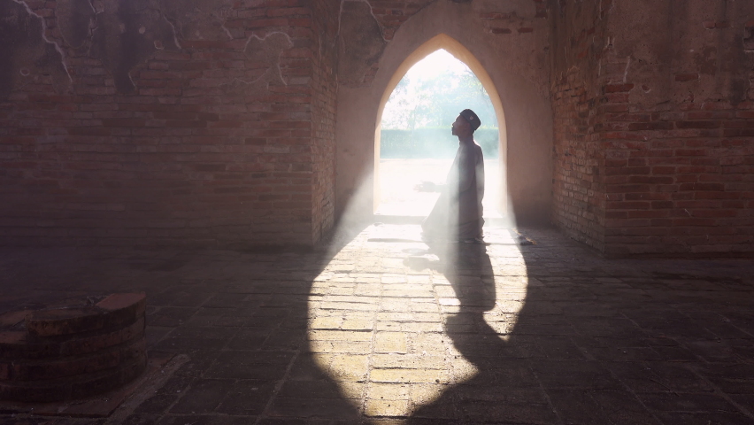 Silhouette of Muslim men praying at the old mosque There is a background of light and smoke, in the holy month of Islam Ramadan. | Shutterstock HD Video #1070274139