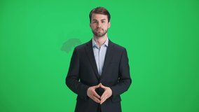 Man reporter in suit looks into the camera and speaks, stands on a green background, a template for TV news agencies, journalist at work, chromakey. - Powered by Shutterstock - Get 15% off with code: PIKWIZARD15