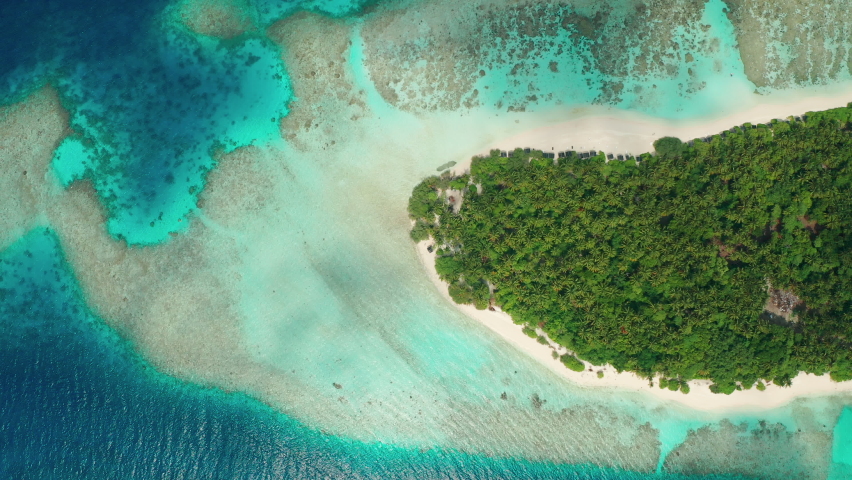 Drone view of a tropical island and corral reef in the Indian Ocean. The concept of a paradise vacation | Shutterstock HD Video #1070282041