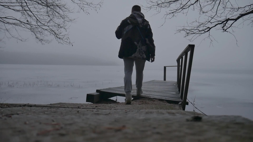 A lonely lake walk in foggy rainy autumn weather