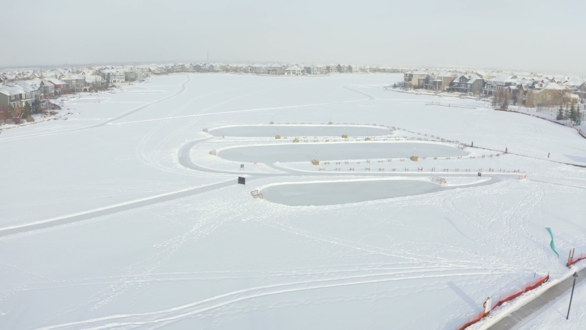 Beautiful aerial view of three outdoor hockey ice rinks on the Auburn Bay lake in Calgary, Alberta