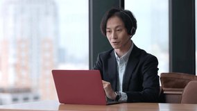 young Asian businessman remote working using computer