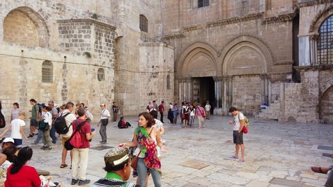 Jerusalem, Israel - July 3, 2019: Pilgrims and tourist visiting and leaving the Church of the Holy Sepulchre in the old town, 4k video footage