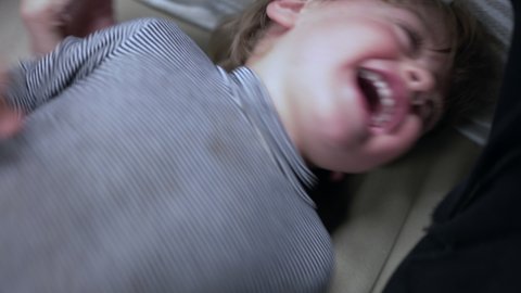 Parent tickling baby toddler child boy. Kid laughing