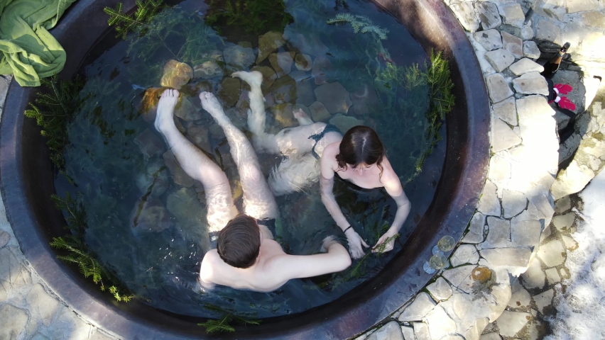 Couple Bathing In Vats Outdoor In Winter Forest. Open Air Bath Outdoors In Winter.