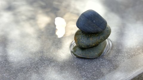 Zen stone stacking at pool with sun rise. Video about spa relaxation during summers spring.