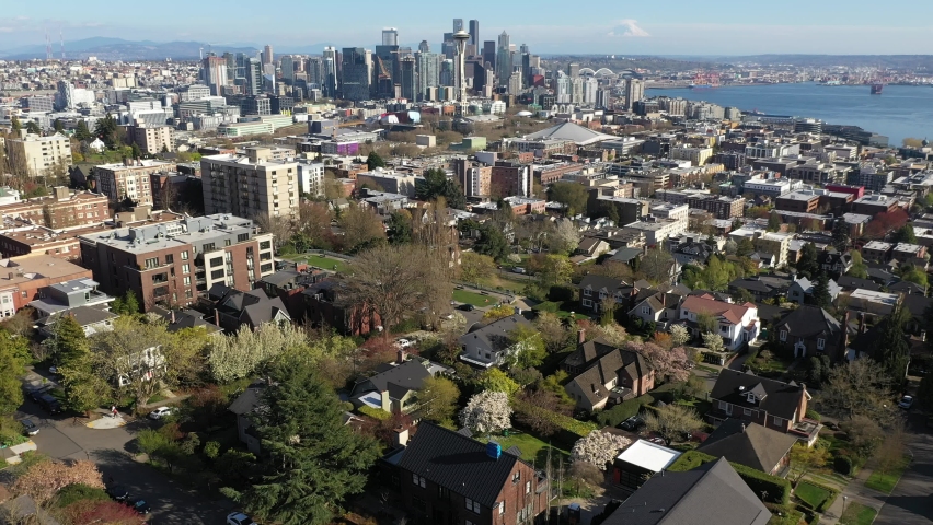 Cinematic aerial drone footage of Kerry Park, downtown Seattle, Belltown, Danny Triangle, Seattle Center, Space Needle, Elliott Bay, skyscrapers, office and residential buildings in Seattle