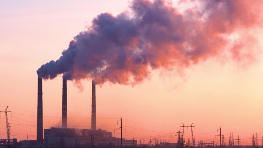Sunset over the industrial city.Factory chimneys smoke.Environmental problem of environmental and atmospheric pollution.Climate change,environmental disaster.The sky is smoky with toxic substances | Shutterstock HD Video #1070306644
