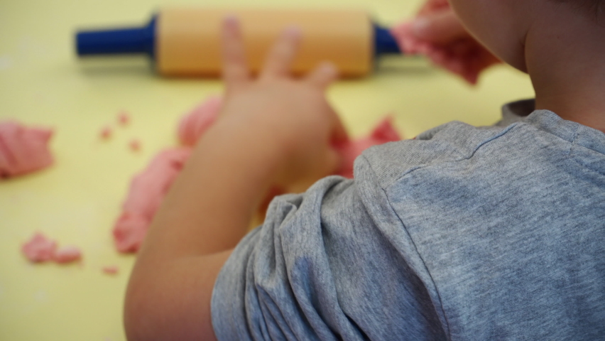 a child in preschool playing with dough 