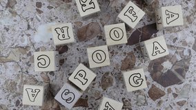 Spoof concept with frame of random alphabet letters on wooden cubes viewed top down on a marbled stone background. Rotating table - Powered by Shutterstock - Get 15% off with code: PIKWIZARD15