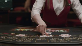 Croupier behind gambling table in a casino. Dealer shuffles the cards. Nightlife - Powered by Shutterstock - Get 15% off with code: PIKWIZARD15