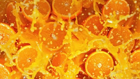 Super Slow Motion Shot of Fresh Orange Juice Splashing through Orange Slices at 1000fps.