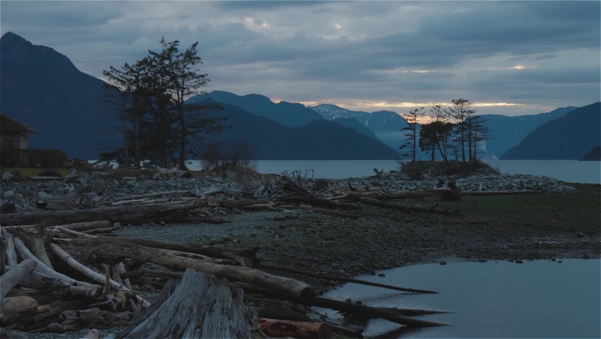 Panoramic View of Canadian Mountain Landscape on the Pacific Ocean Coast. Winter Sunset Sky. Howe Sound between Squamish and Vancouver, British Columbia, Canada. Slow Motion