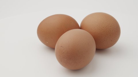 ingredient; egg carton; eggs isolated; eggs breakfast; eggs; egg rotate; egg roll; egg rolls; clean; symbol; texture; business concept; close-up; yolk; rotate; rotating; brown; hand; nutrition; roll; 