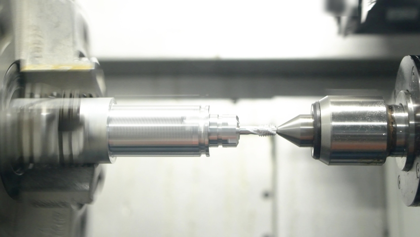 Cnc machine at work. cutting tool processing steel metal detail on turning cnc lathe machine in workshop | Shutterstock HD Video #1070327257