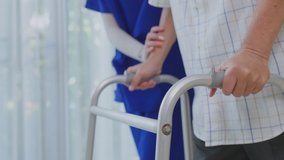 Close up a hands of Asian young woman nurse at nursing home taking care disabled elderly man. Caregiver doctor giving a physical therapy for older patient practice walking on walker or cane at house. - Powered by Shutterstock - Get 15% off with code: PIKWIZARD15