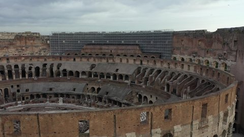 The Colosseum in Rome with aerial view on the Palatine mountain. Colosseo, Coliseum. Aerial shot with drone of Ancient Rome.