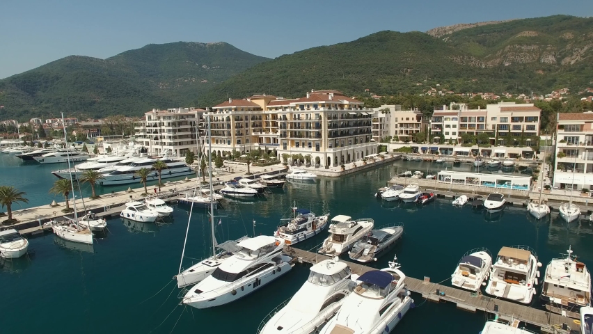 View of the Porto Montenegro marina in Tivat, yachts and boats at the pier, hotel complex Royalty-Free Stock Footage #1070340862