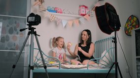 Little Girl with her Mother Recording New Content for Vlog about Handmade Toys at Home. Social Media Influence People, Content Maker, Streaming Online Podcast at Home Concept