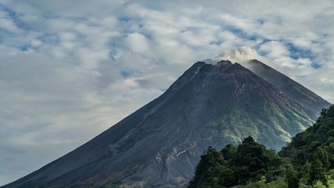 Timelapse Merapi Volcano Erupts in the Morning. Mount Merapi several times emitted incandescent lava and "awan panas". Clear weather around mountain.