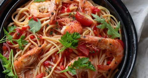 Pasta with shrimps, top view, rotate