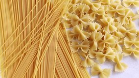 Dry raw pasta and spaghetti on the white background