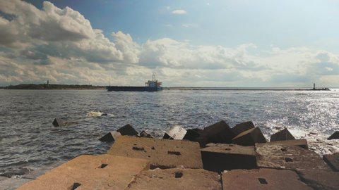 A cargo ship enters the harbor on the Daugava River.