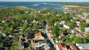 Kuressaare in the Baltic sea,Saaremaa island, Saare County, Estonia. Beautiful 4K panoramic aerial video from flying drone to Kuressaare (Arensburg) city and Lawrence of Rome church a sunny summer day