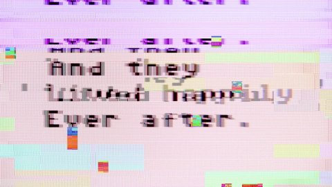 Intentional glitch distortion noise effect while typing words on a computer monitor: and they lived happily ever after. Macro detail shot.
