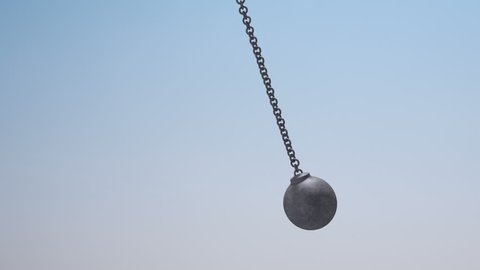 Swinging wrecking ball. Animation of rocking steel ball with black and white mask.