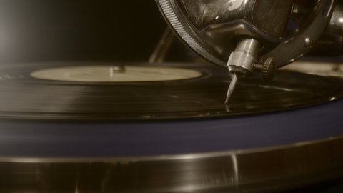 Dolly zoom needle of an old gramophone playing music on a vinyl record. Macro Close up