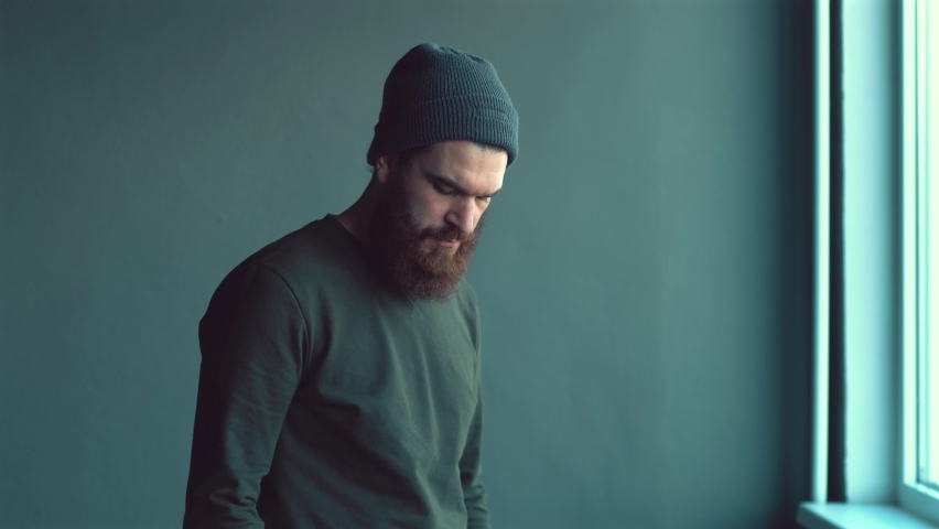 Footage of bearded hipster man using hand sanitizer